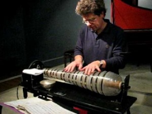 Modern Glass harmonica player Thomas Bloch– note the bowl of water for moistening his fingers.