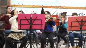 Children between the ages of five and nine learn how to play musical instruments such as the clarinet, cello and violin [Julie Ovgaard/Al Jazeera]