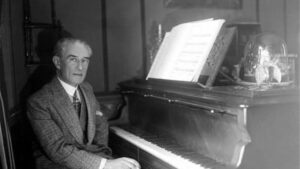Composer Maurice Ravel sitting at the piano