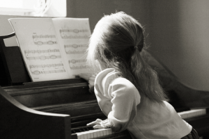 child learning piano