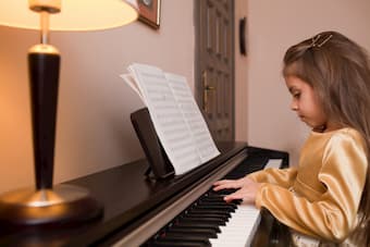 Little girl practicing piano