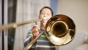 A child practising trombone