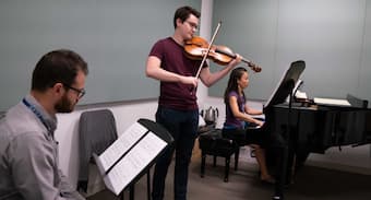 Composer Noah Meites sits in on a rehearsal of his own work with musicians