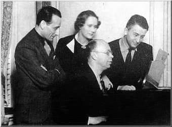 Alexander Tansman at the home of Vladimir Golschmann and his wife in St. Louis (U.S.A.) in 1931, watching while Prokofiev tries out Tansman's Second Concerto on the piano. ( Photo: Ruth Cunliff Russel, St. Louis, U.S.A. )