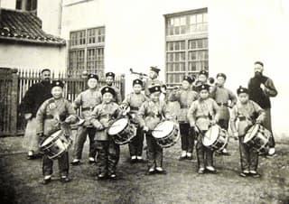 François Ravary (far right at the back) conducting the drum and bugle corps of the College of St. Ignatius, Zikawei (Xujiahui), Shanghai, around 1880.   