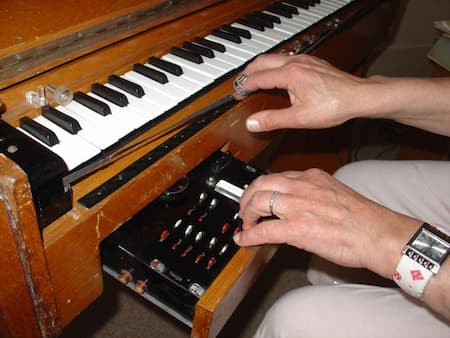 Ondes martenot being played on the ribbon (note the ring on the right pointer finger) and the left hand controller