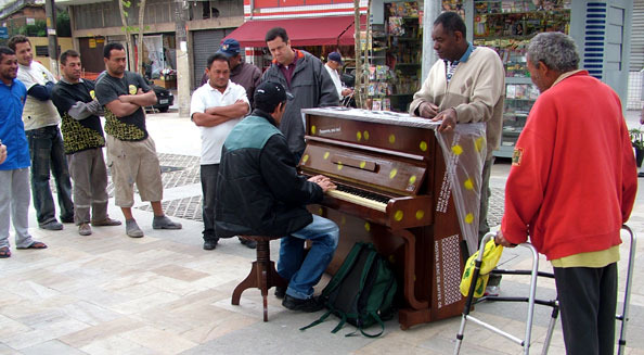 people playing the street piano for fun