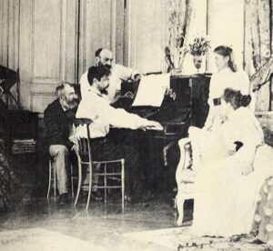 Photo of composer Ernest Chausson turning pages for Debussy