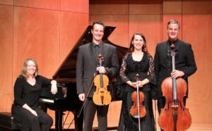 Photo showing a classical piano quartet instrument line-up: piano, violin, viola and cello