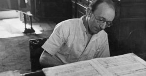 Pianist Clifford Curzon reading a music score