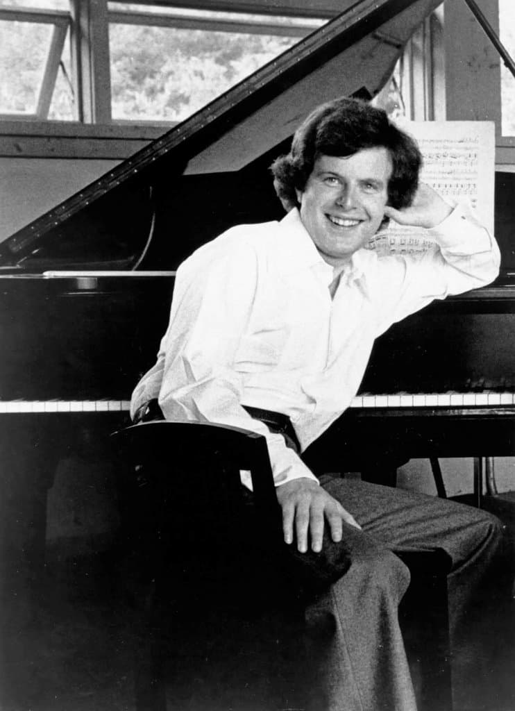 András Schiff sitting at the piano