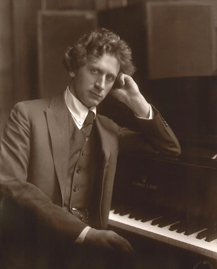Percy Grainger posing at the piano