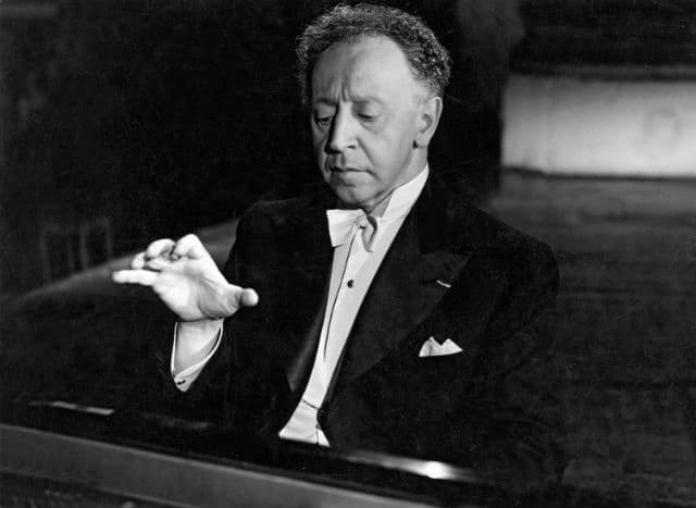 Polish-American Pianist Arthur Rubinstein playing the piano