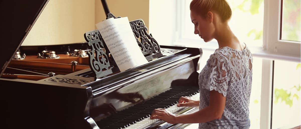 beautiful girl sitting down playing the piano