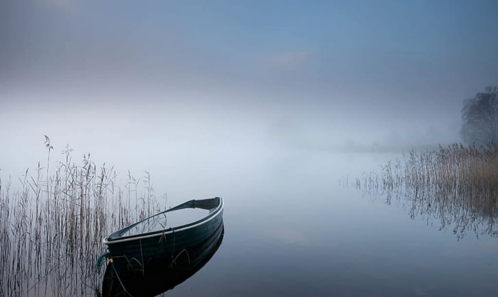 Boat on foggy lake