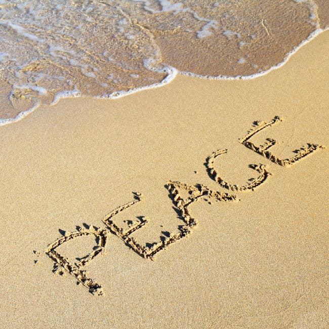 "Peace" written on a beach