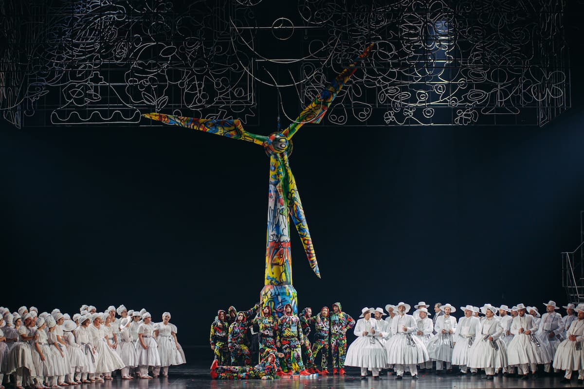 Pagliacci: Children’s choir on left, ninjas in the middle with the wind turbine, and adult chorus on right, 2024 (GNO) (Photo by Valeria Isaeva)