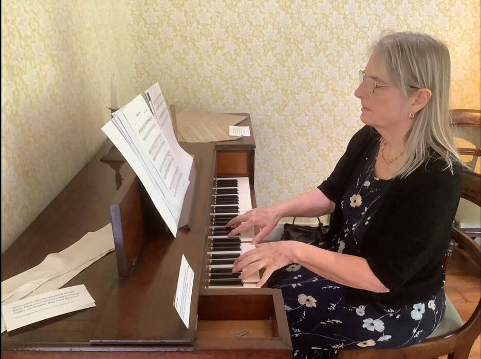 Author Gillian Dooley playing an Austen era piano