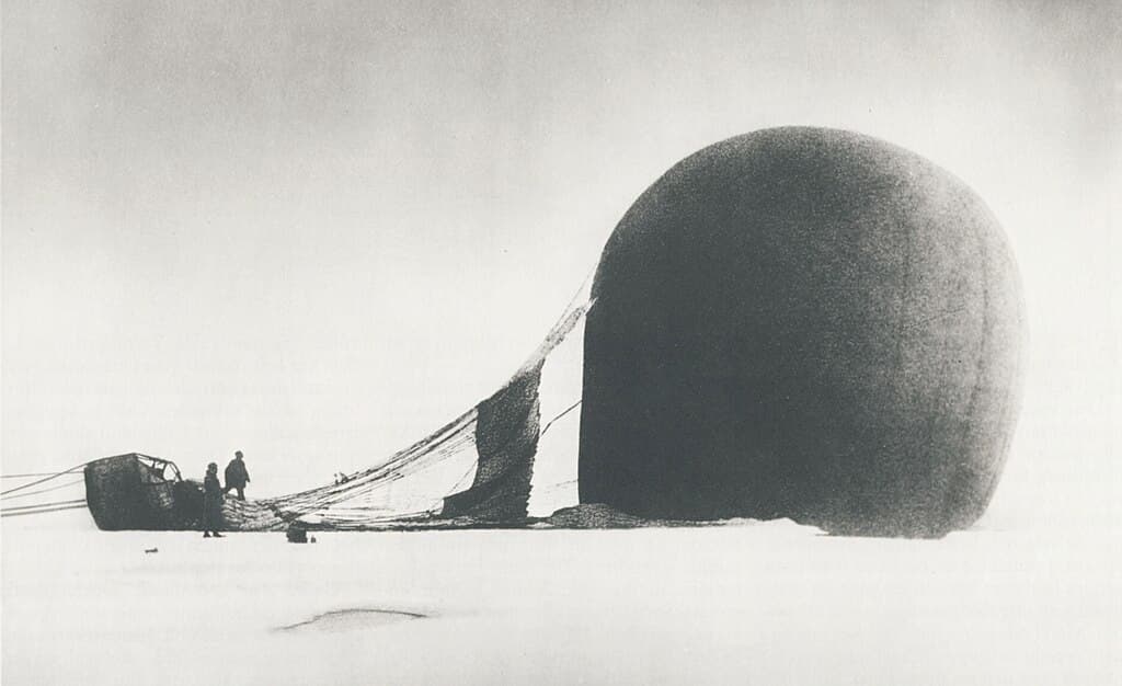 S. A. Andrée and Knut Frænkel with the polar balloon Örnen (Eagle)on the pack ice, photographed by the third expedition member, Nils Strindberg. The exposed film for this photograph and others from the failed 1897 expedition was recovered in 1930.