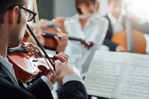 Violinist performing with the classical orchestra