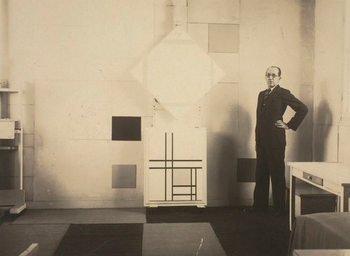Mondrian in his Paris studio with Composition with Yellow Lines, 1933