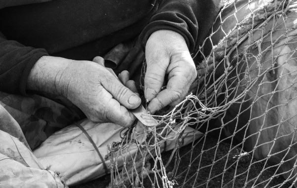  A fisherman repairing his nets at Sanlúcar de Barrameda
