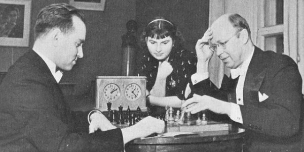 Prokofiev playing chess against David Oistrakh with violinist Liza Gilels watching