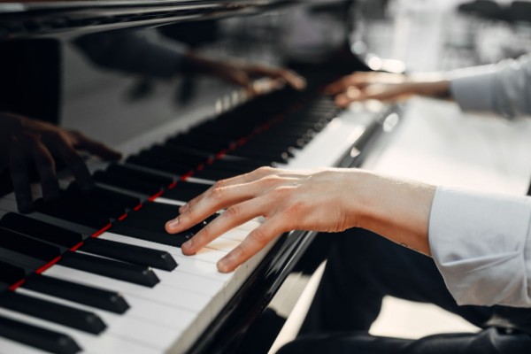 An adult playing the piano