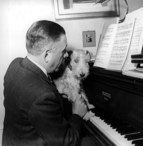Francis Poulenc plays on the Pleyel piano with his dog, Mickey