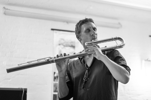 Frank Gratkowski playing a bass flute, 2019 (photo by Alex Kiausch)